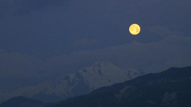 full moon over the Alps by travel photographer Jacques Aloïs Morard