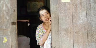 iban, dayak woman looking from her door by jakalois